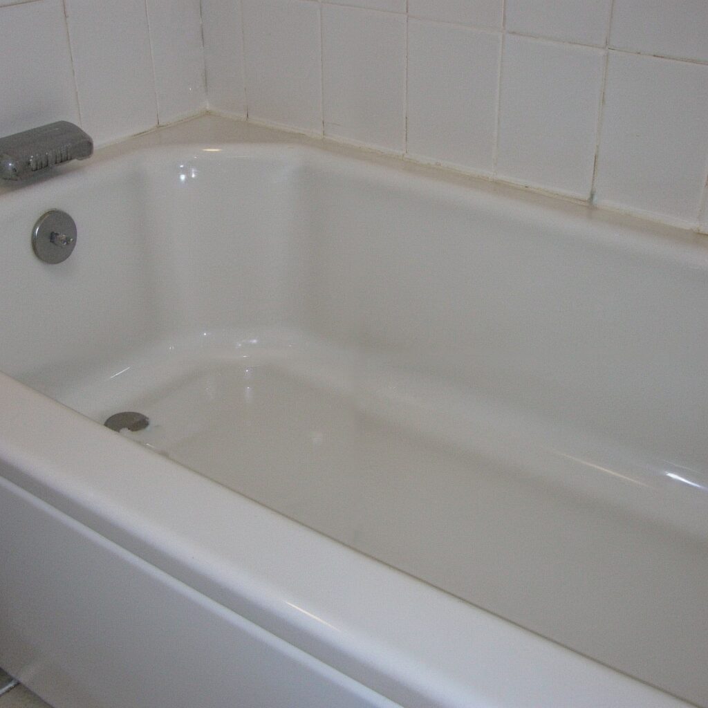 Clean and waterproof bathtub sealed with silicone sealant to prevent leaks and mold buildup.